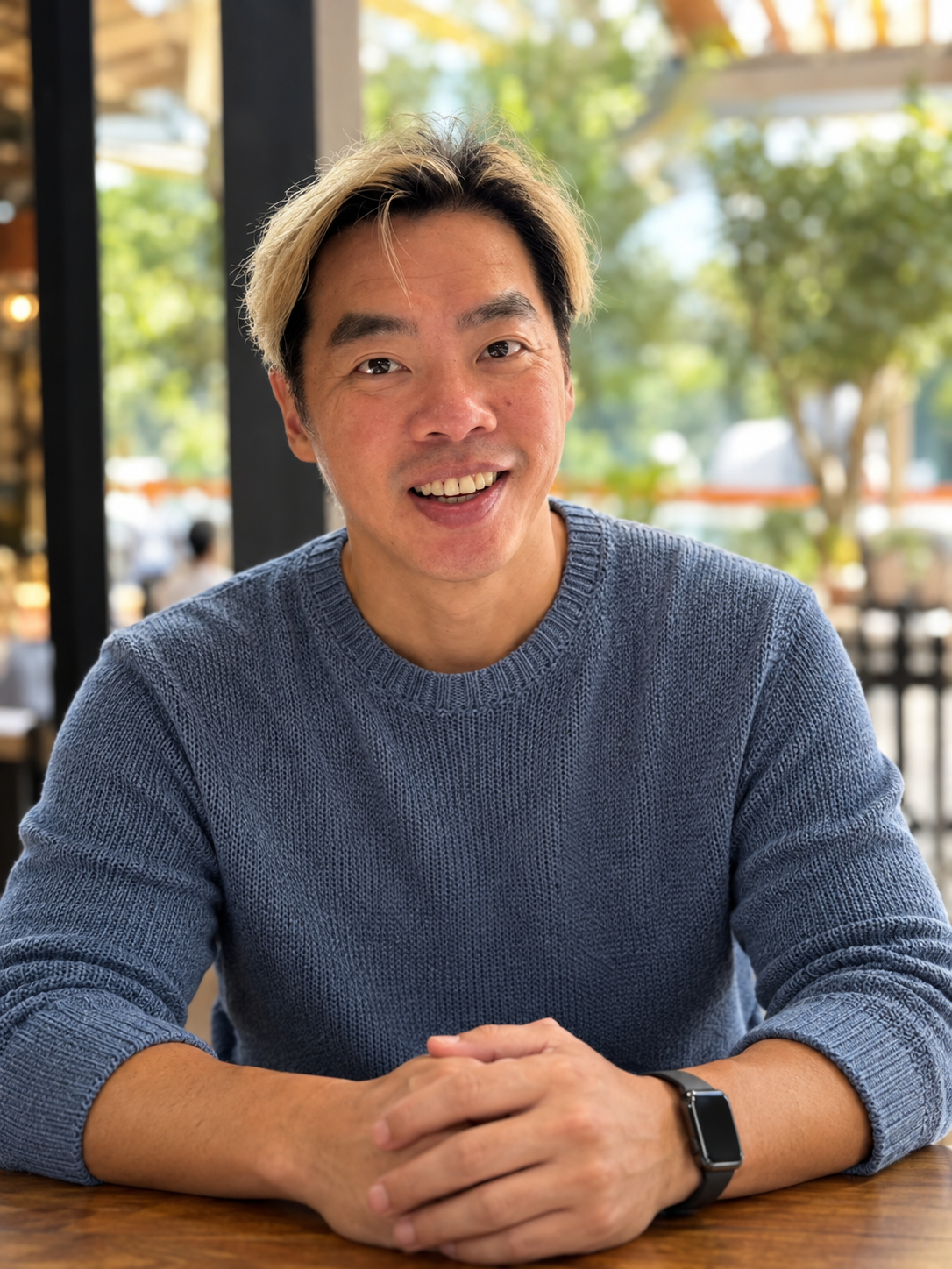 Shawn Ng smiling at a table